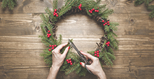 Making Christmas wreath using fresh materials.