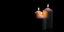 Candles burning on black background